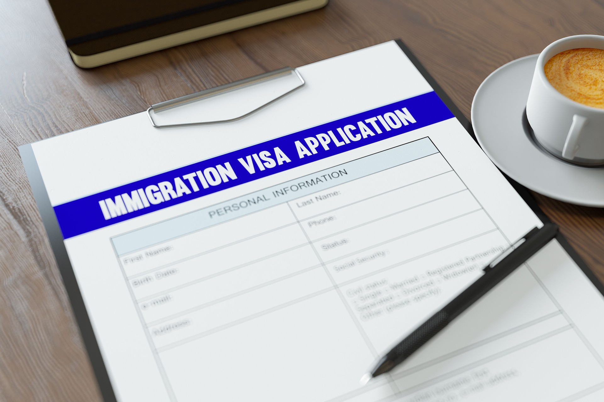 Immigration Visa Application Form with Coffee and Pen